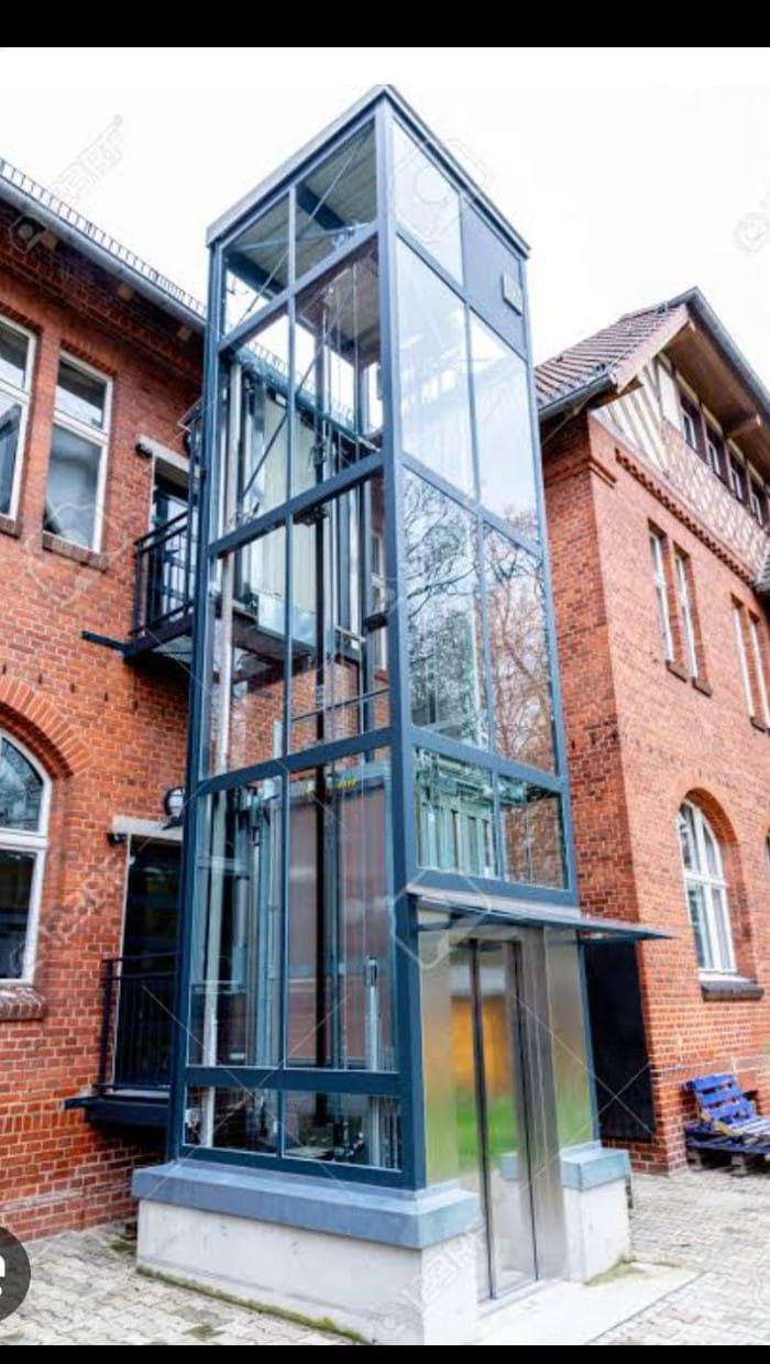 External glass elevator on brick building